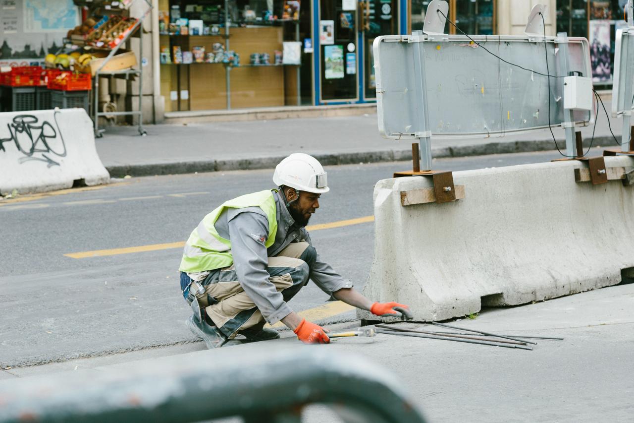 Worker installing steel reinforcement bars on site